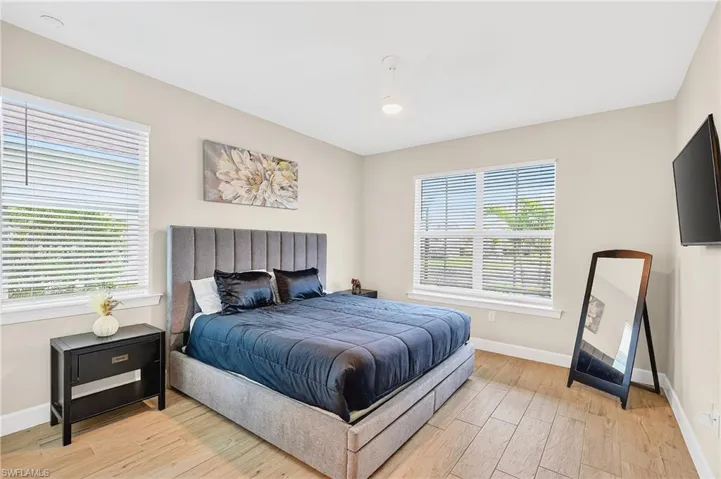 Bedroom with light wood finished floors and ceiling fan