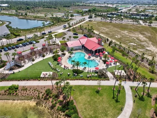 Aerial view of a pool area and a large body of water
