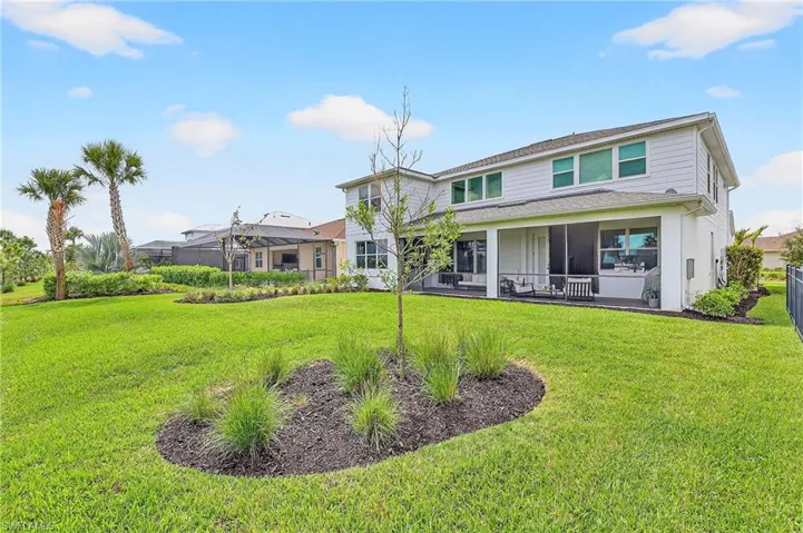 Back of property with a lawn and a patio