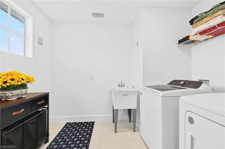 Laundry room featuring baseboards and washing machine and clothes dryer