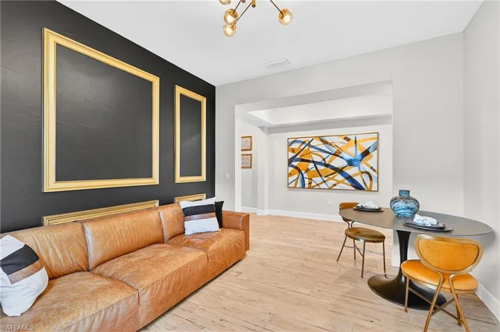 Living room featuring light wood-style floors and hanging lights