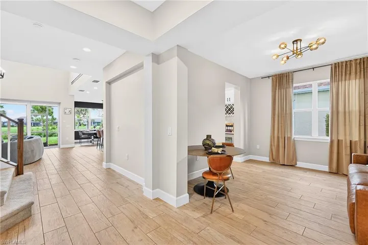 Corridor with wood finish floors and recessed lighting