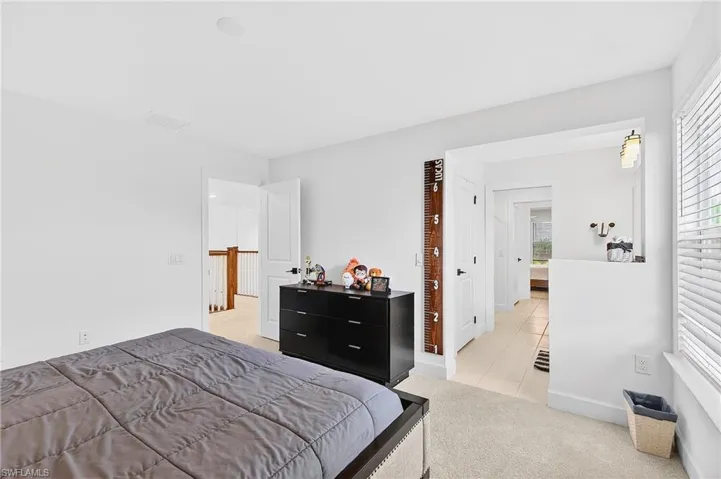 Bedroom featuring light carpet and light tile patterned flooring