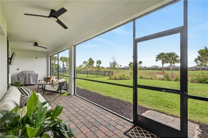 Sunroom / solarium featuring a ceiling fan and a residential view