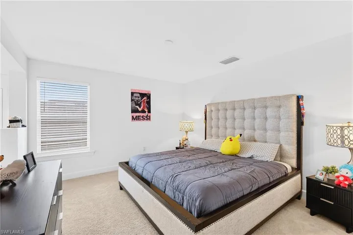Bedroom featuring carpet and baseboards