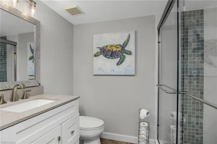 Owner's bedroom has an ensuite bathroom, featuring an updated tile walk in shower, and a new vanity.