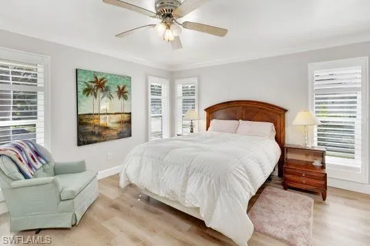 Bedroom with light wood-style flooring and ceiling fan