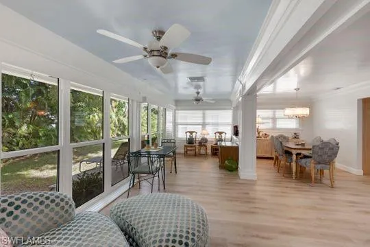 Sunroom featuring wood finished floors and baseboards