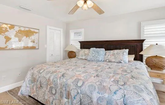 Bedroom featuring a ceiling fan and a closet