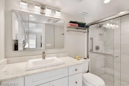 Bathroom featuring vanity, a stall shower, and recessed lighting