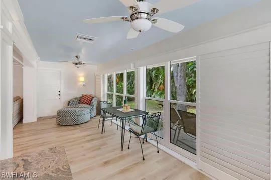 Sunroom with plenty of natural light and wood finished floors
