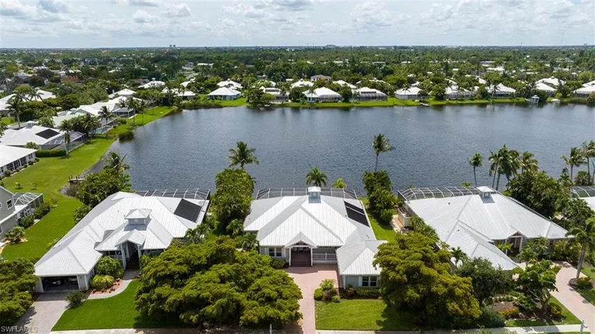 Birds eye view of property with a water view