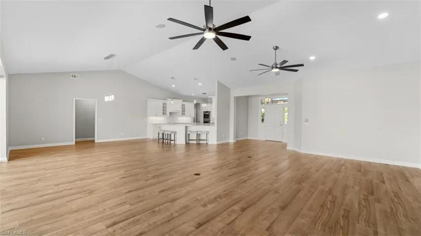 Living room / dining area with high vaulted ceilings