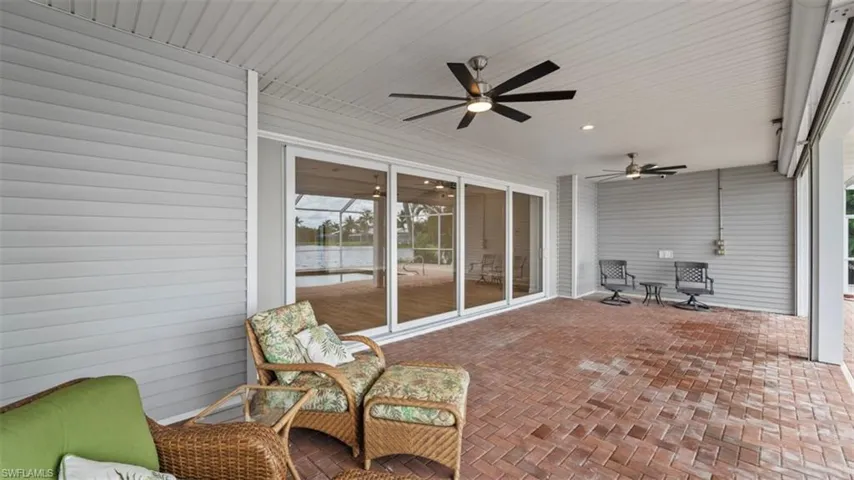 Large covered patio area with electric roll down hurricane shutters.