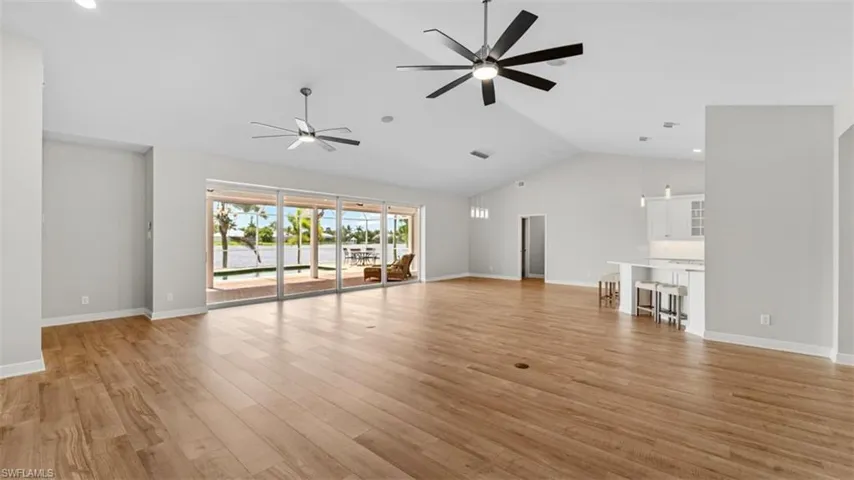 Living room featuring high vaulted ceilings and expansive lake views