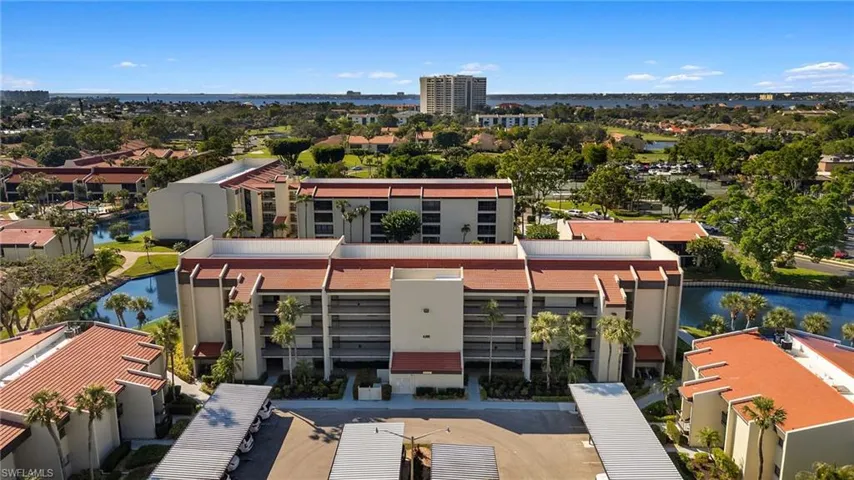 Birds eye view of property with a water view