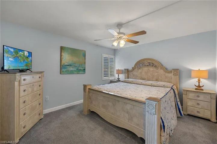 Bedroom with ceiling fan and carpet flooring