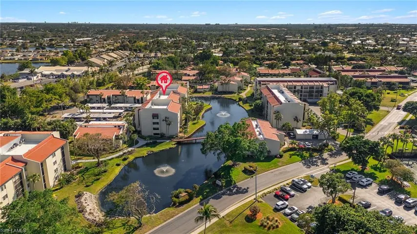 Birds eye view of property with a water view