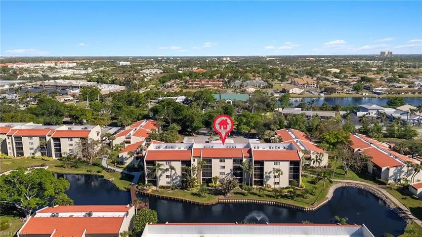 Birds eye view of property with a water view