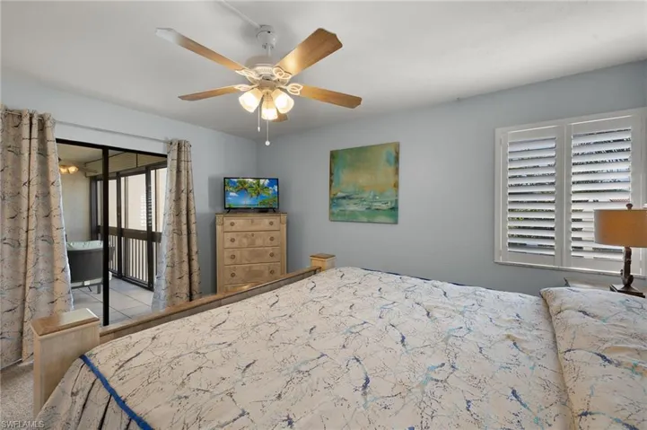 Bedroom with access to exterior and ceiling fan