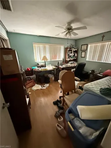 Misc room with ceiling fan and wood-type flooring