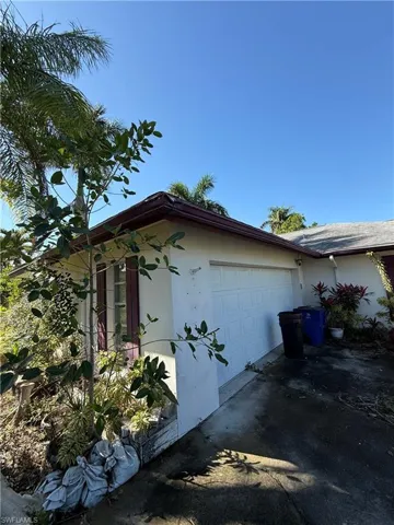 View of property exterior with a garage