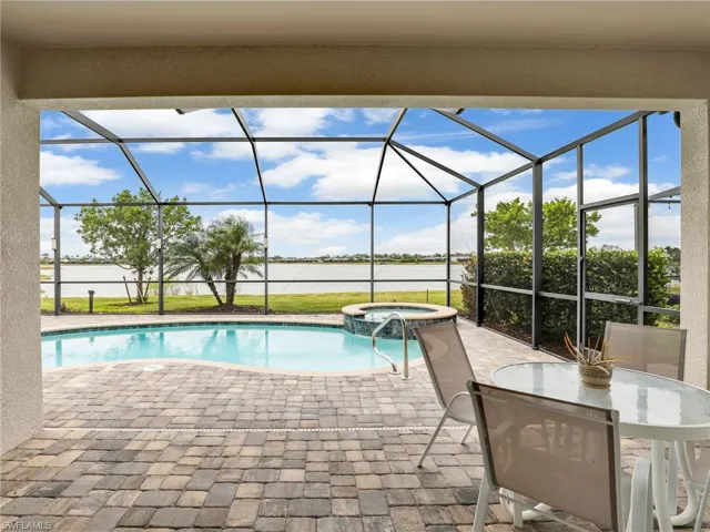 Covered lanai leads to screened pool and spa
