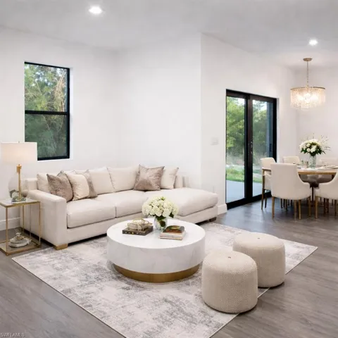 The living area features recessed lighting, durable flooring, and a large window providing natural light