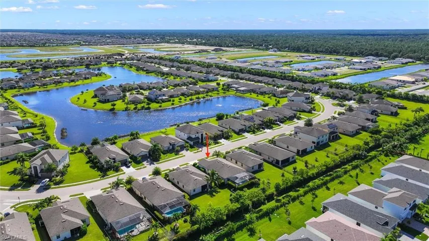 Panoramic Aerial View Featuring the Community’s Winding Lakes, Homes, and Green Spaces.