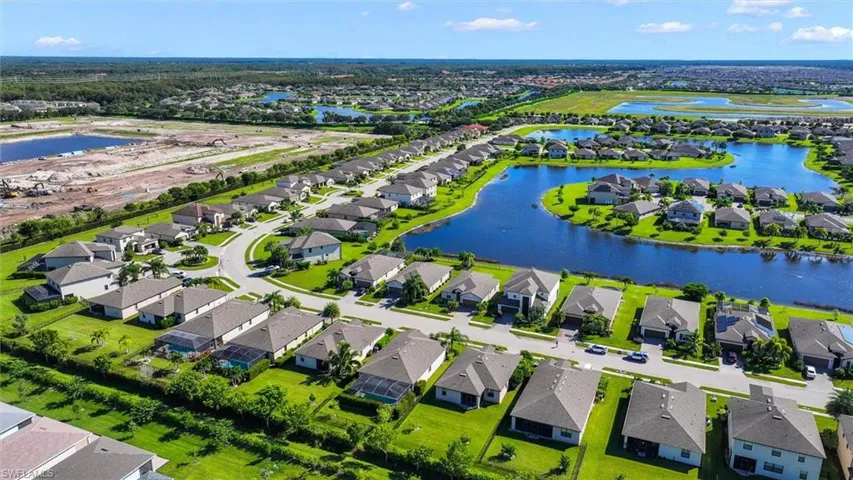 Aerial Neighborhood View Showcasing the Beautiful Community and Surrounding Lakes.