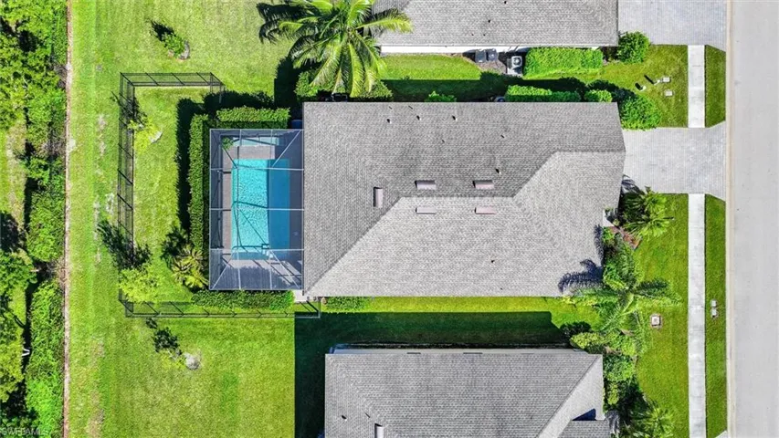 Bird’s-Eye View of the Home with a Screened Pool and Fully Fenced Backyard.