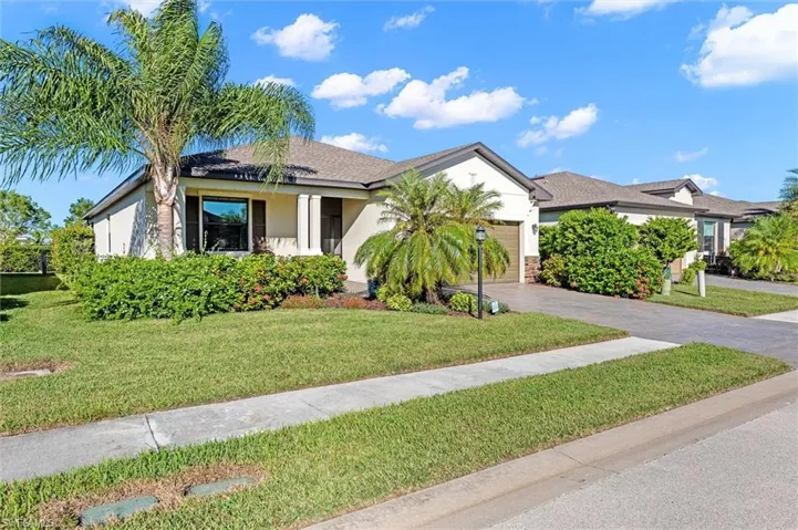 Welcome home to Portico! Beautiful tropical landscaping, a paver driveway, and a two-car garage.