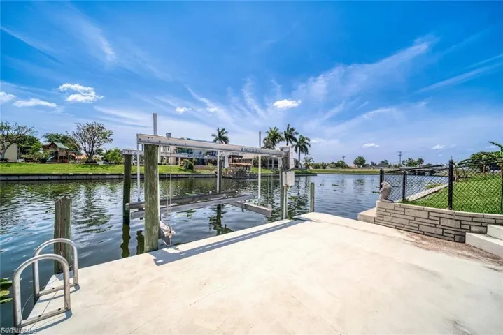 Dock area featuring a water view and boat lift