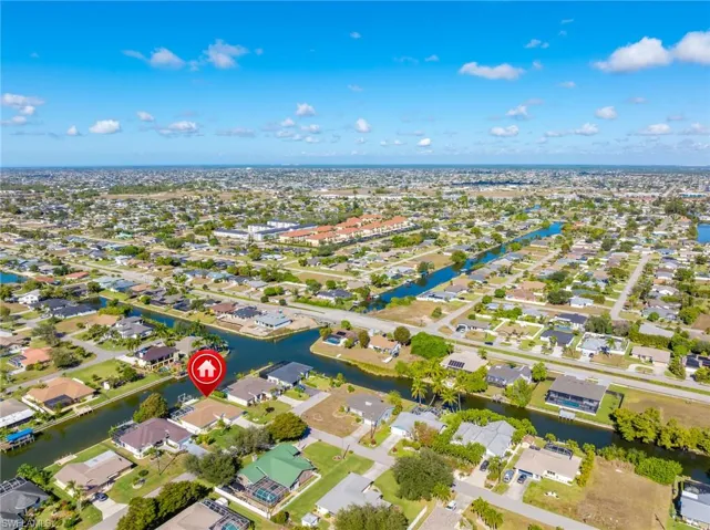 Aerial perspective of suburban area featuring a large body of water