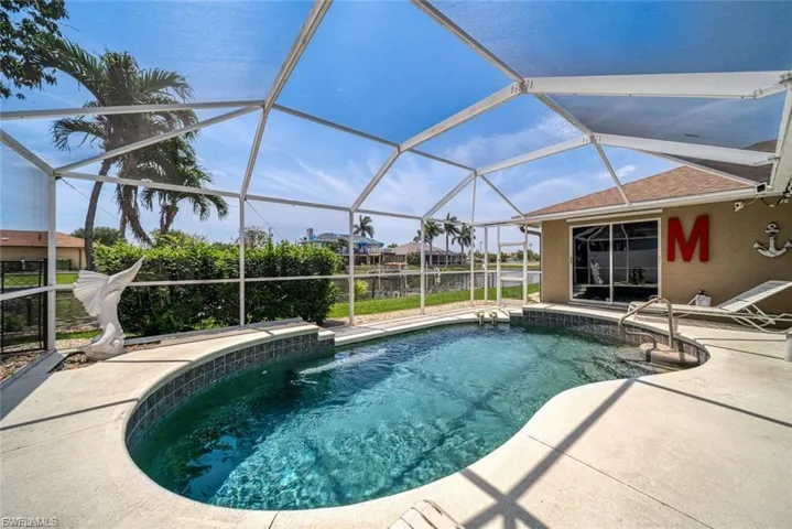 Swimming pool featuring a sunroom, a lanai, and a patio