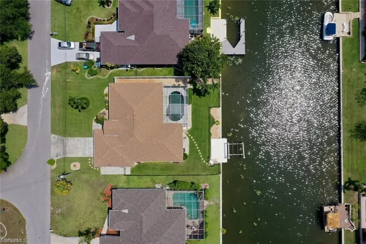 Aerial view of property's location with a large body of water
