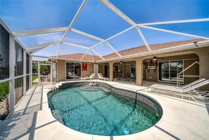 Swimming pool with a sunroom, a patio, and a lanai
