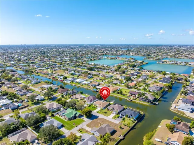 View of property location with a nearby body of water and nearby suburban area