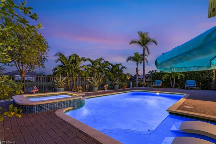 Integrated pool / hot tub featuring a fenced backyard and a patio area