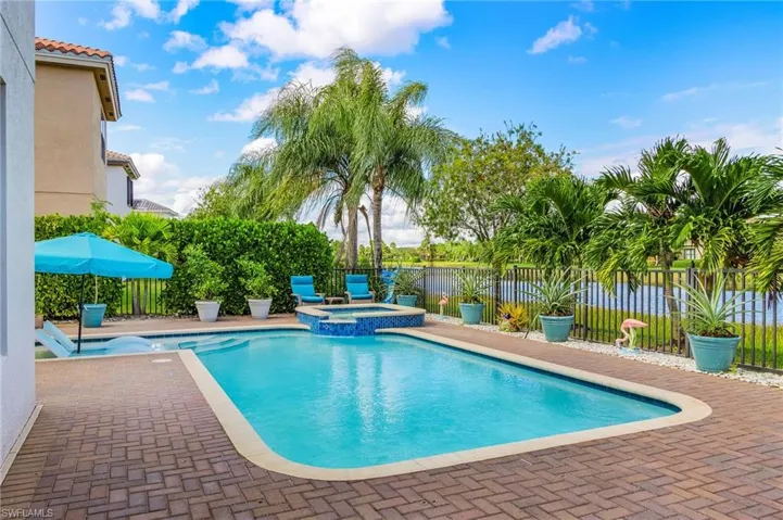 Relaxing pool / spa with a fenced backyard and a patio area