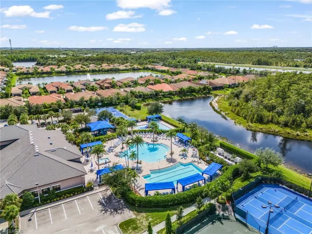 Aerial view of residential area with a pool area and a large body of water