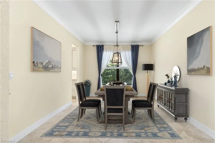 Dining area with ornamental molding and baseboards