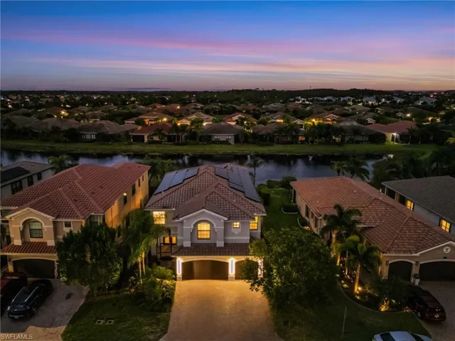 Aerial view at dusk of a water view and a residential view