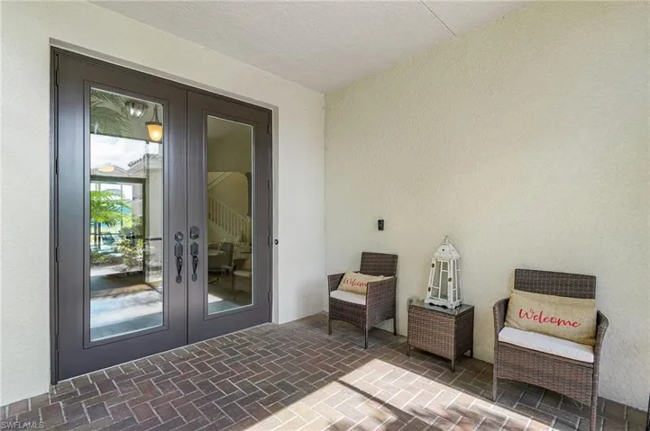 View of exterior entry featuring french doors and stucco siding