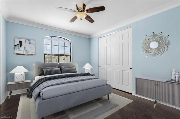 Bedroom featuring ornamental molding, ceiling fan, dark wood-style flooring, and a closet