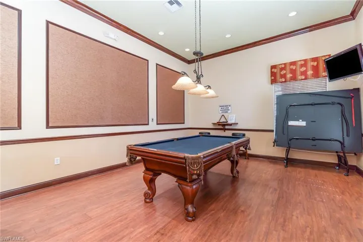 Game room featuring wood finished floors, ornamental molding, billiards, baseboards, and recessed lighting