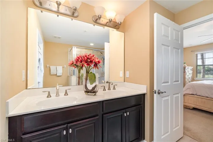 Ensuite bathroom with double vanity and a shower with shower door