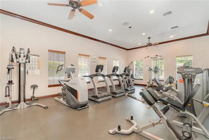 Workout area with ceiling fan, baseboards, crown molding, and recessed lighting