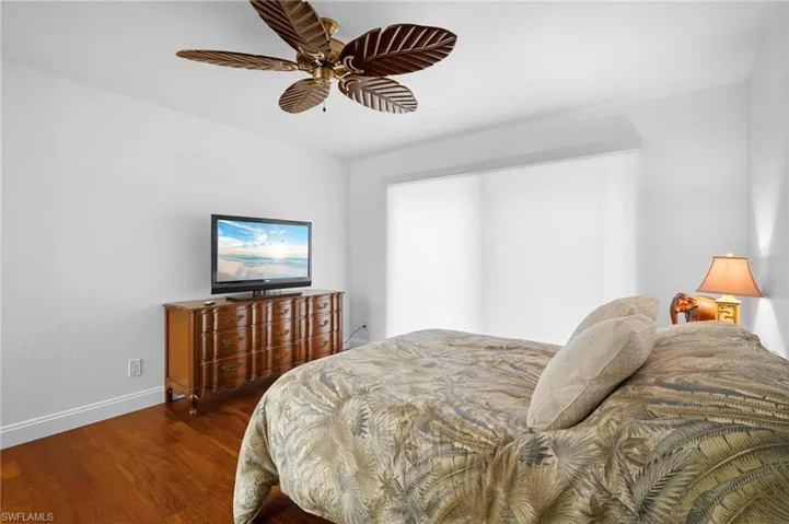 Bedroom featuring wood finished floors and ceiling fan