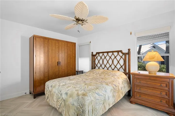 Bedroom with ceiling fan, a closet, and parquet flooring